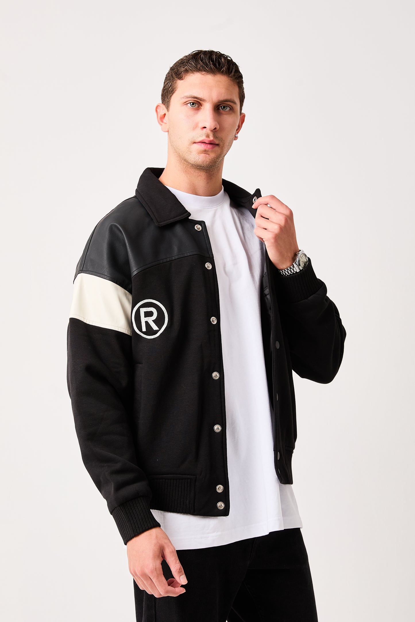 X-2005 Mens Varsity Bomber Jacket Black Snap Button Faux Leather Shoulder Panel Color Block Sleeve Ribbed Hem Fleece Lined