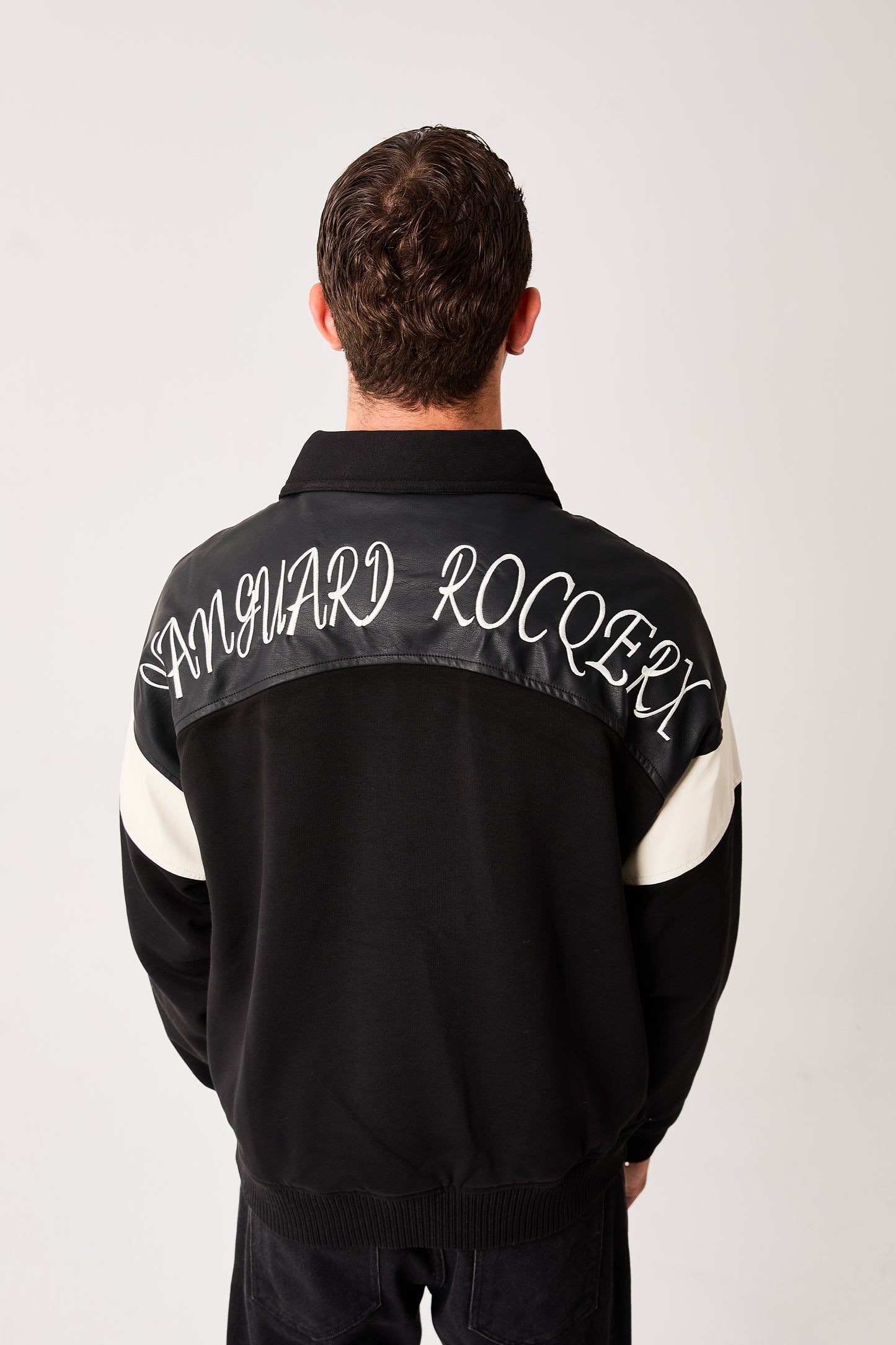 X-2005 Mens Varsity Bomber Jacket Black Snap Button Faux Leather Shoulder Panel Color Block Sleeve Ribbed Hem Fleece Lined